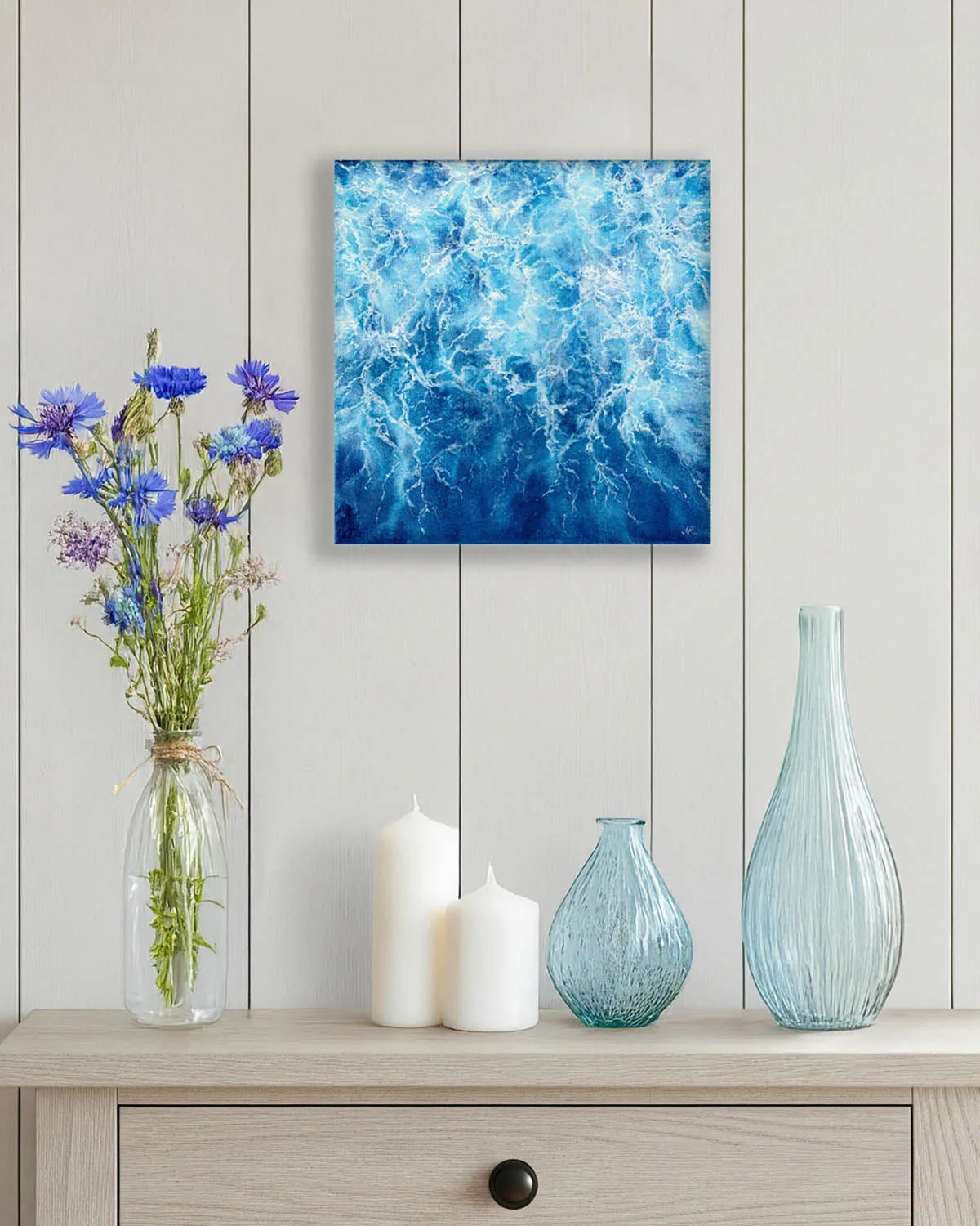 "Liquid Energy" abstract ocean watercolor painting on canvas displayed on a wall, featuring flowing blue sea tones and contemporary coastal decor for a modern interior.