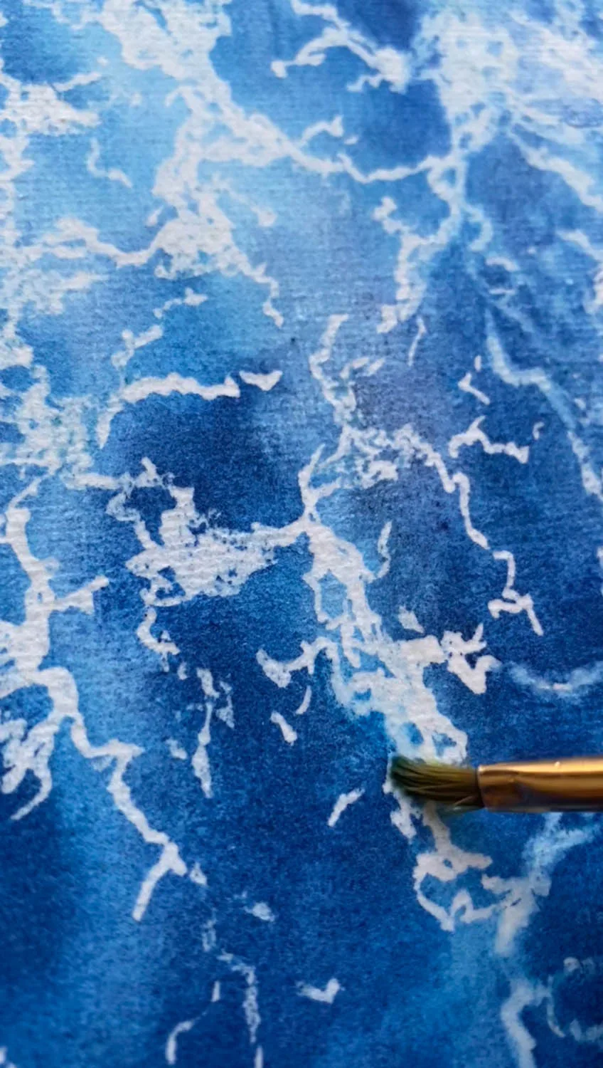 Work in progress of "Liquid Energy" abstract seascape watercolor painting on canvas, with visible brushstrokes and flowing blue pigments illustrating the movement and energy of the sea.