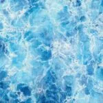 Close-up of Liquid Energy abstract seascape watercolor, showing swirling blue tones and transparent layers that reflect ocean currents and fluid movement.