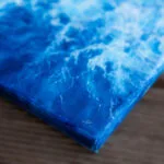 Signature of Kateryna Nazarenko on "Liquid Energy" abstract blue ocean watercolor painting on canvas, original fine art inspired by sea movement.