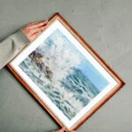 Stormy Tide Rush fine art print framed and ready to hang, featuring stormy ocean waves and coastal spray in vivid watercolor tones