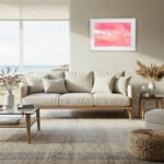 Large pink landscape watercolor painting "Pink Lakes of Ukraine" above a beige sofa in a modern living room, ideal for statement wall decor with calming mineral colors.