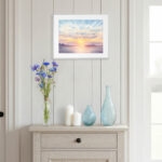 Coastal sunset watercolor wall art print with warm pastel tones of sun and sky, ocean seascape print for modern coastal interiors