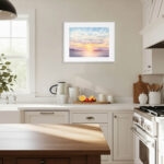 Fine art print of watercolor painting Sunset Dream, featuring soft golden glow of sunset over calm ocean waters with distant mountains