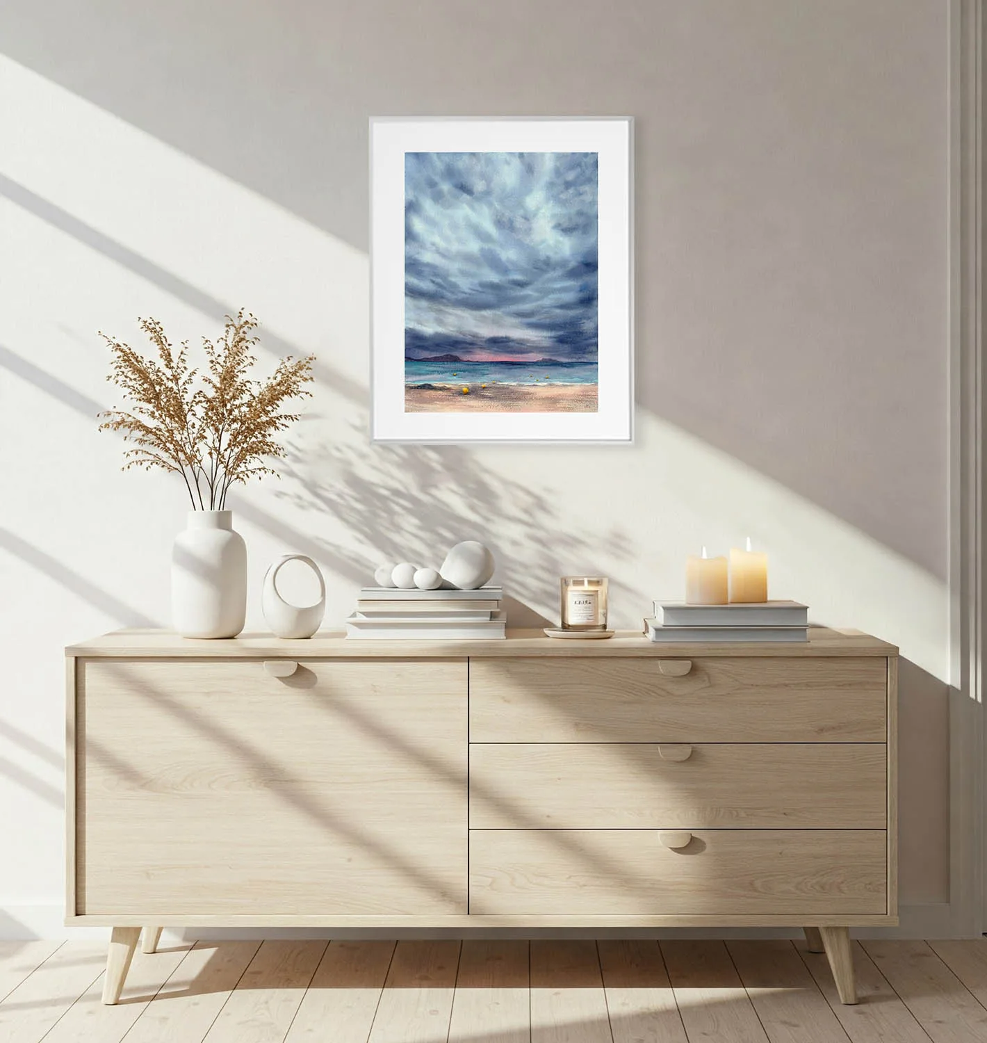 Framed After Dark watercolor seascape painting of ocean horizon and stormy sky, displayed in a modern living room interior