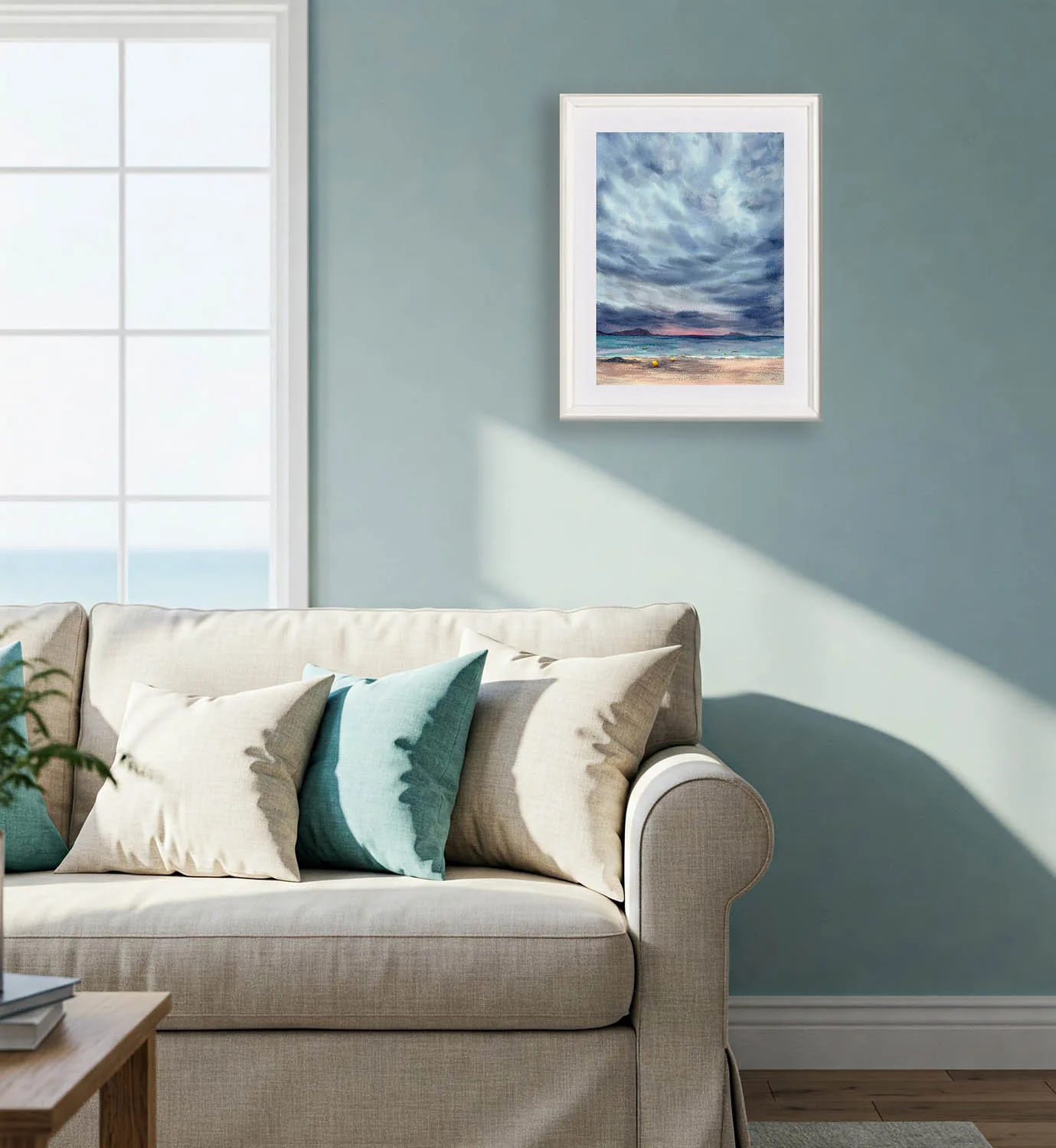 After Dark seascape watercolor artwork with dramatic storm clouds and fading light styled in a coastal living room above the sofa, perfect for beach house decor