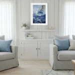 Bravery sailing boat watercolor painting framed in a coastal living room, showcasing dramatic storm waves, ocean spray, and nautical wall art that adds dynamic marine energy to the décor.