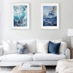 Bravery sailboat in rough sea watercolor framed in a minimalist living room, creating a striking focal point with dramatic ocean waves and intense nautical atmosphere.