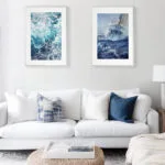 Bravery sailboat in rough sea watercolor framed in a minimalist living room, creating a striking focal point with dramatic ocean waves and intense nautical atmosphere.