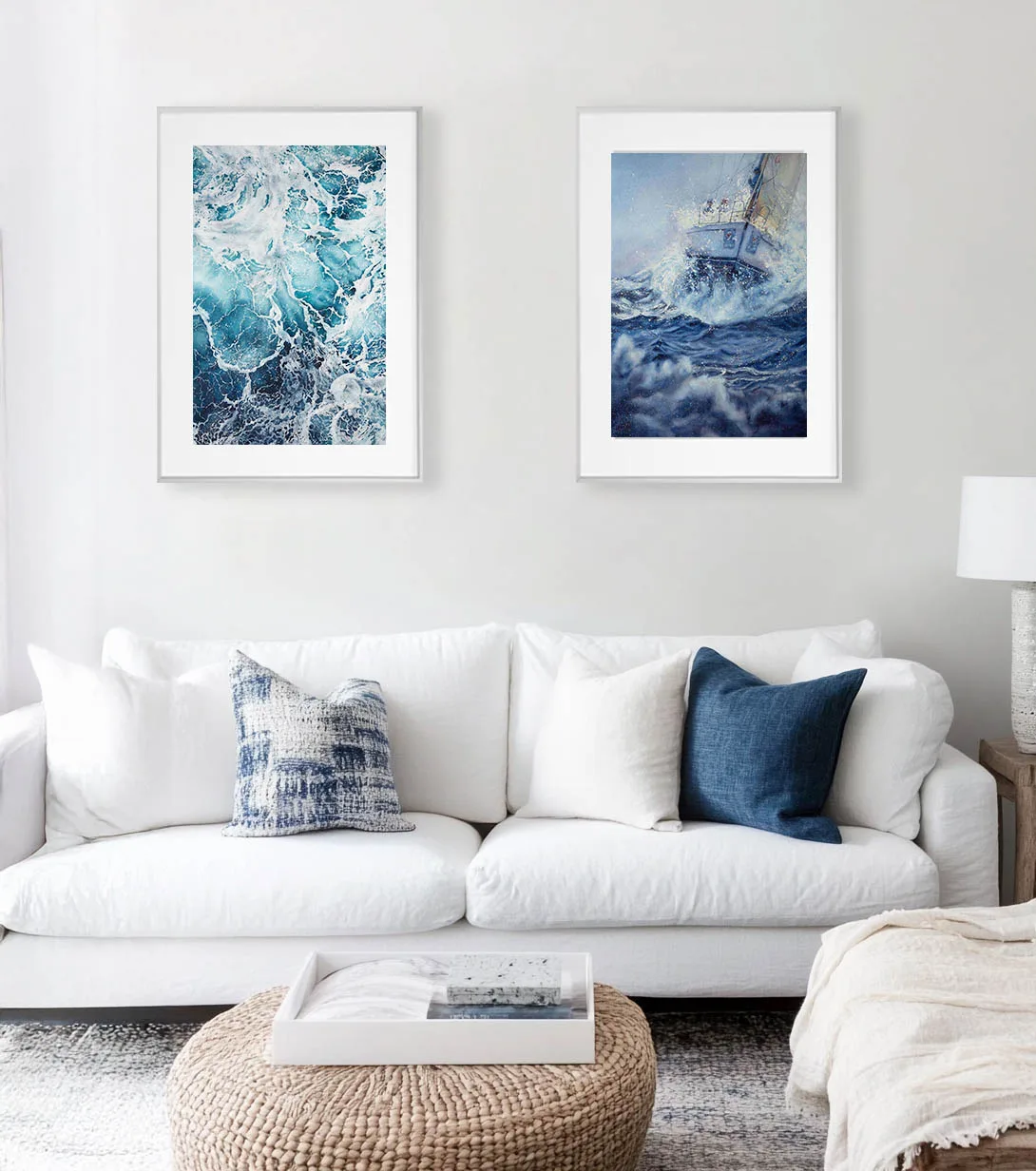 Bravery sailboat in rough sea watercolor framed in a minimalist living room, creating a striking focal point with dramatic ocean waves and intense nautical atmosphere.