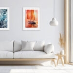 Red Sails original watercolor painting framed in a coastal living room, featuring glowing sunset colors, red sails, and ocean reflections — nautical wall art perfect for beach house décor and modern coastal interiors.