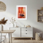 Warm sunset sailboat watercolor artwork with red sails and shimmering sea reflections, nautical fine art for beach house or coastal wall decor.