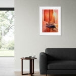 Red Sails watercolor sailing painting displayed above the sofa in a contemporary living room, adding warm sunset tones, nautical charm, and ocean-inspired wall art to coastal home décor.