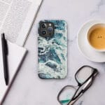 Deep blue turquoise ocean watercolor iPhone case with MagSafe on table