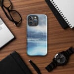 Stormy blue grey ocean watercolor iPhone case with MagSafe on table