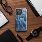 Deep blue ocean watercolor iPhone case with MagSafe on table