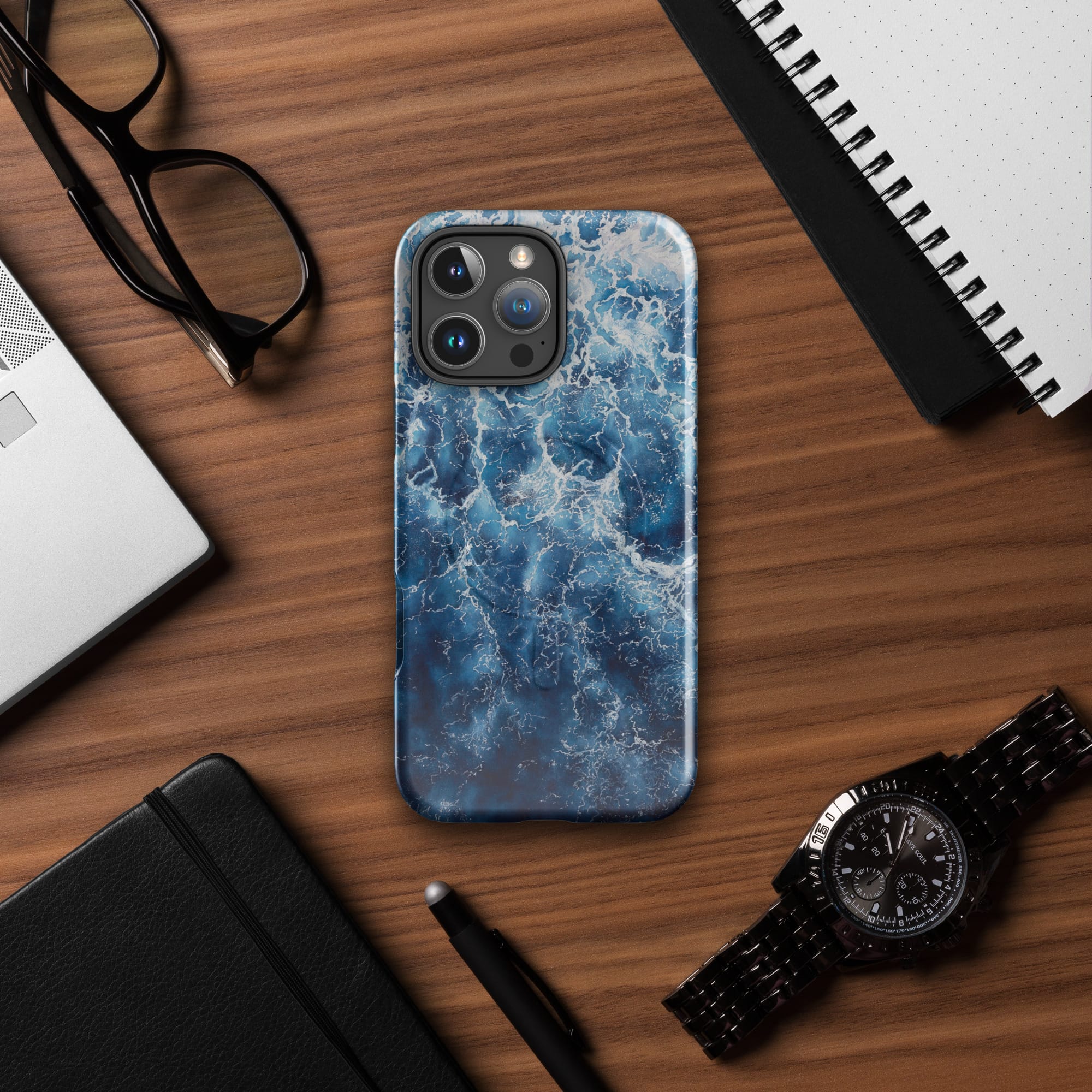 Deep blue ocean watercolor iPhone case with MagSafe on table