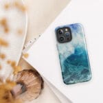 Blue ocean wave watercolor iPhone case with MagSafe on table