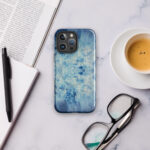 Light blue ocean water surface watercolor artwork printed on a MagSafe iPhone case