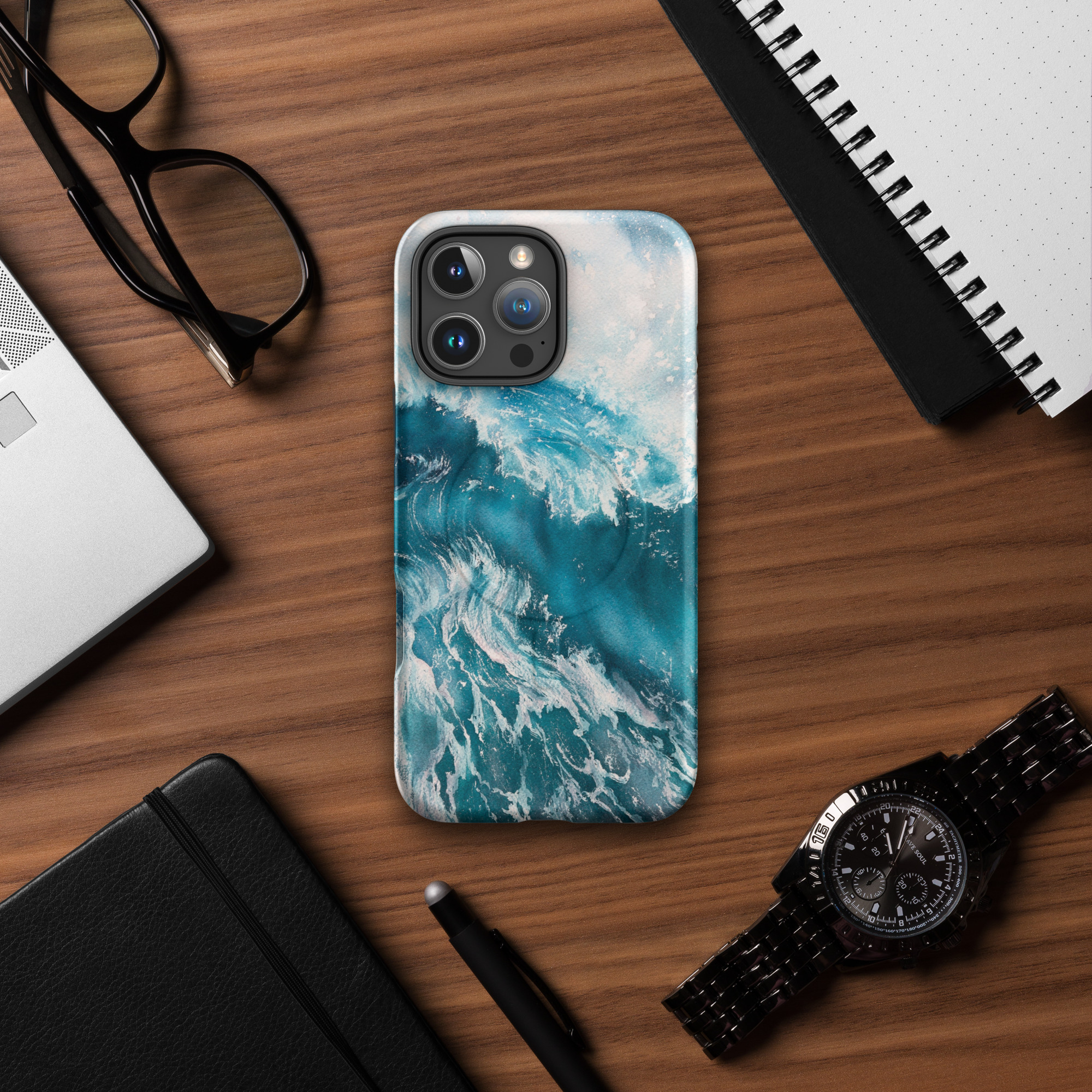 Turquoise blue ocean wave watercolor iPhone case with MagSafe on table